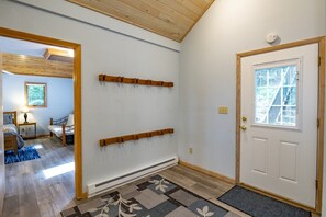 A hallway with a white door, a radiator, and a window with blinds. - Robin`s Perch - 318 Northpoint Way (Davis)