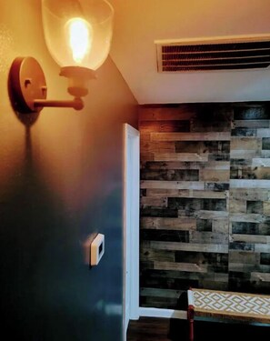 Cozy retreat with a rustic wall design and functional layout.