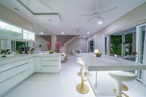 Enjoy cooking in this well-equipped kitchen with a central island, sink, and large window offering a view of the outdoors.