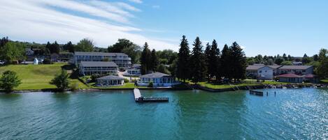 A lakeside hotel with multiple buildings, a dock, and a gazebo.