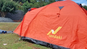 A red tent with the brand name 'tendaki' visible on its side. - Bukit Shoka Top View Camp (Giricahyo)