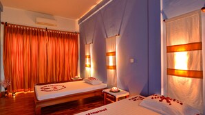 A hotel room with two beds, a wooden floor, a large window with curtains, and a wall-mounted air conditioner. - One Myanmar Resort Nay Pyi Taw (Naypyidaw)