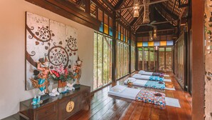 A traditional wooden room with tatami mats, a large mural, and a statue. - Khaolak Oriental Resort - Adult Only (Takua Pa)