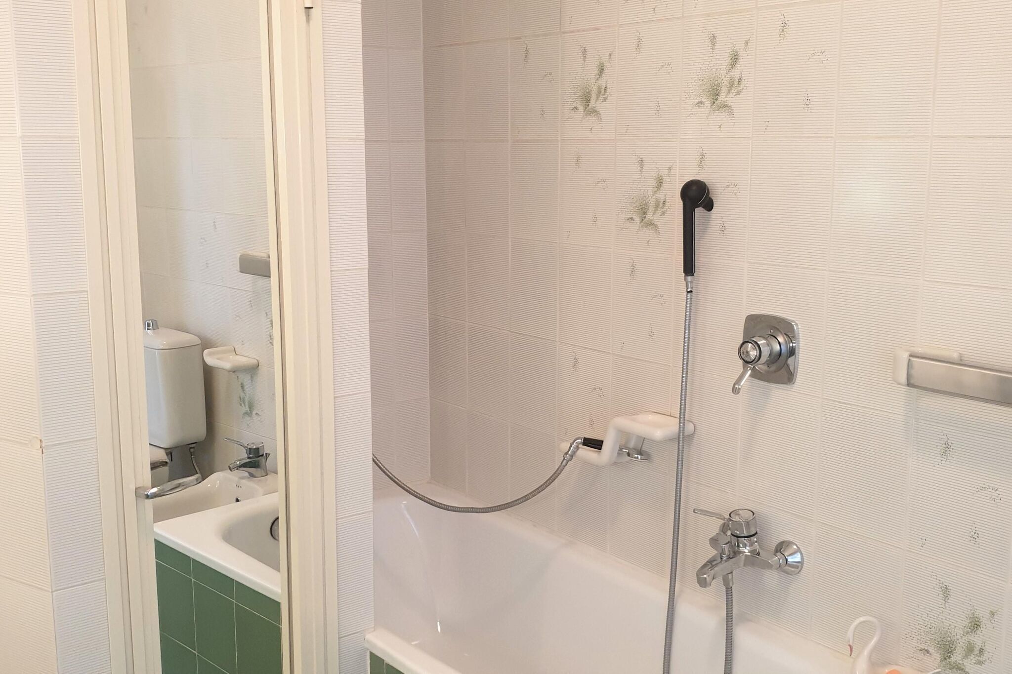 A bathroom with a bathtub, a shower, and a toilet.