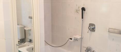 A bathroom with a bathtub, a shower, and a toilet.