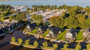 A marina with boats, houses, and a waterway. - Water Villa in Balk with Lake Access (Balk)