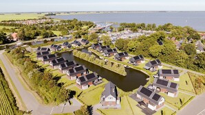Un quartier résidentiel où les maisons sont disposées autour d’un plan d’eau central, et reliées par des sentiers.