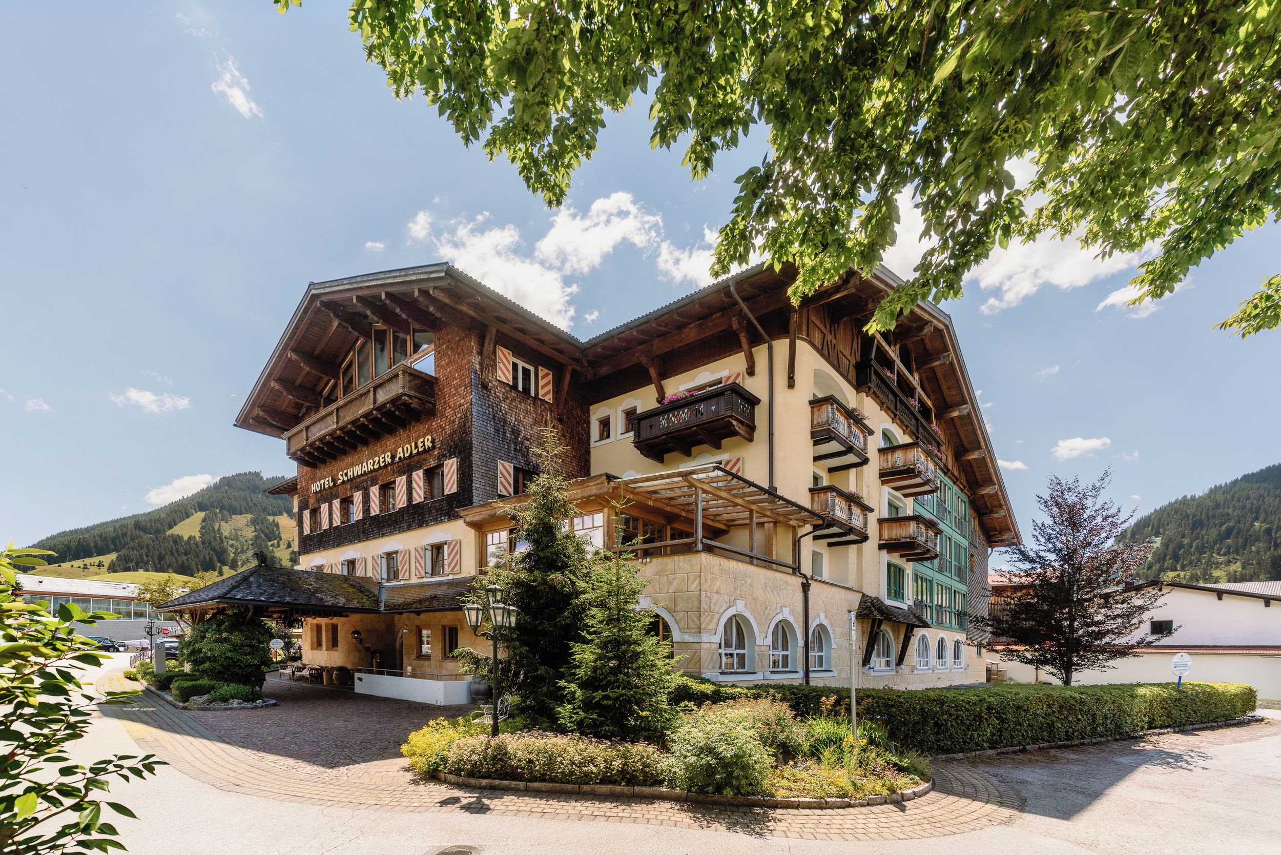 Un hotel de estilo chalete tradicional con múltiples balcones y un paisaje de montaña.
