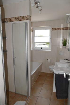 Bathtub, hair dryer, towels, soap