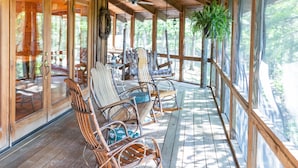 A wooden deck with rocking chairs and a ceiling fan. - 15 Bedroom, Hot tub, Put Put, Pond, Pool Table (Needmore)