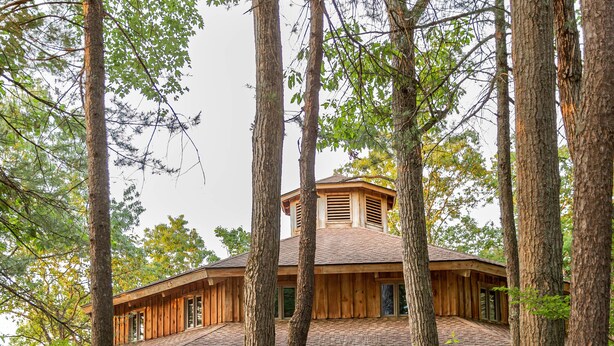 A wooden cabin with a porch, surrounded by trees and a stone path leading to the entrance. - 15 Bedroom, Hot tub, Put Put, Pond, Pool Table (Needmore)