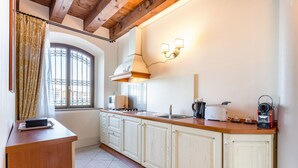 A kitchen with a stove, toaster, and cabinets.