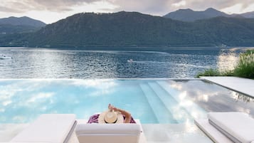 Una piscina al aire libre de temporada, sombrillas