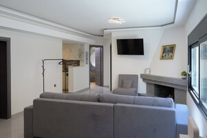 Family Apartment | Living area | 32-inch Smart TV with cable channels