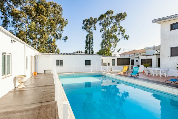 Seasonal outdoor pool, open 9:00 AM to 7:00 PM, pool loungers