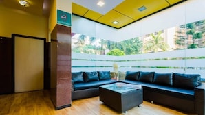 A modern lobby with a black leather sofa, a coffee table, and a 'No Smoking' sign. - HOTEL AIRPORT ANNEX (Mumbai)