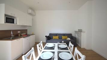 Exclusive Apartment | Living area | 100-cm flat-screen TV with digital channels, TV, offices