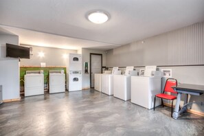 Convenient laundry facilities offer washing machines and dryers with digital controls.