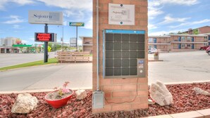 A brick building with a Subway sign, a Sojourn sign, and a digital display indicating furnished apartments. - 1BR with 2 beds and a kitchen on the 2nd floor (Rapid City)