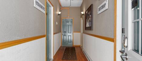 A hallway with wooden floors, cream walls, and two doors labeled "Starshine" and "Berkshire."