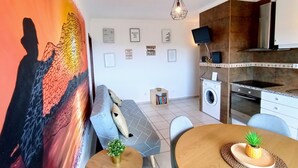 A modern kitchen with a built-in oven, microwave, and a small island with a sink. - Stunning Ocean View! Communal Pool and Quick Walk to the Beach (Portimão)