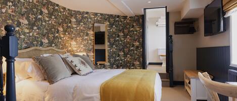 A bedroom with a bed, a mirror, a wooden bench, and a radiator.