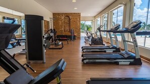 A gym with treadmills, stationary bikes, and weight machines.