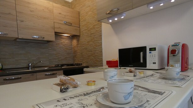 A modern kitchen with a microwave, toaster, and coffee maker.