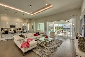Una sala moderna con sofá, mesa de centro y vista al patio exterior.