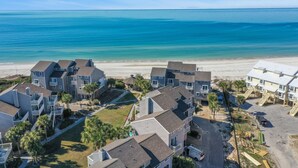 A coastal residential area with multi-story houses, a sandy beach, and a clear view of the ocean. - Beach View, Pet Friendly, 3 BR End-Unit Steps from Beach ~ Sand and Surf (Cape San Blas)