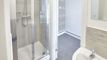 Shower, hair dryer, towels, shampoo