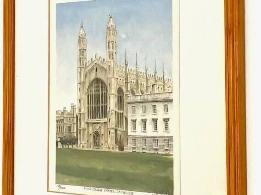 A framed architectural drawing of a large, historic building with two prominent towers and a central entrance.