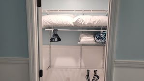 A room with a bunk bed, a shelf with folded clothes, and a hanging rack. - Harrison Hotel Unit E
Pet Friendly
Ground Level (Murrells Inlet)