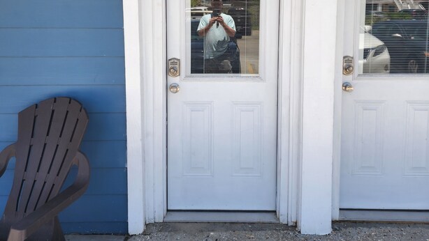 A white door with a window, a brown Adirondack chair, and a concrete ground with a man taking a photo. - Harrison Hotel Unit E
Pet Friendly
Ground Level (Murrells Inlet)
