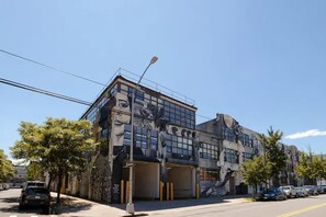 A building with a modern architectural style, featuring large windows and a unique facade with artistic elements. - Dutch Hotel Long Island City New York , Belvilla District 6 Formerly Sonder (New York)