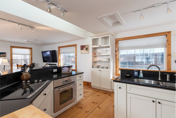 Enjoy cooking in this well-equipped kitchen with a large window offering a view of the surrounding area.