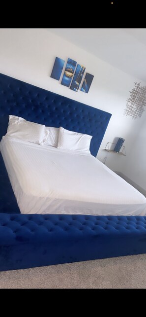 Cozy retreat with a prominent headboard and minimalist decor.