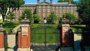 A large brick building with a central clock tower, surrounded by well-maintained lawns and a gated entrance. - Private Apartment with private entrance, Full Bathroom, Living room, Kitchen (Cranston)