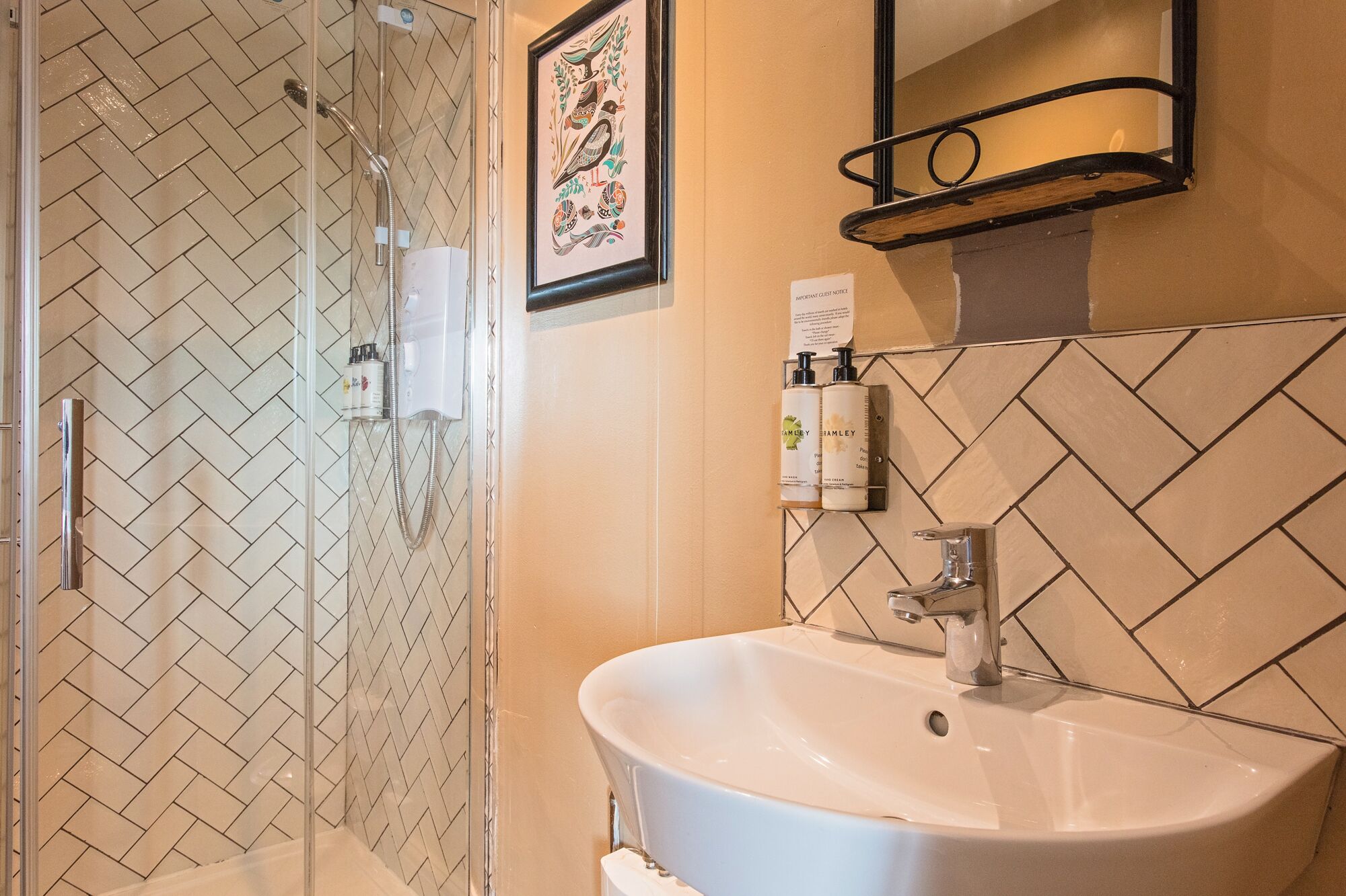 A bathroom with a shower, a sink, and a mirror.