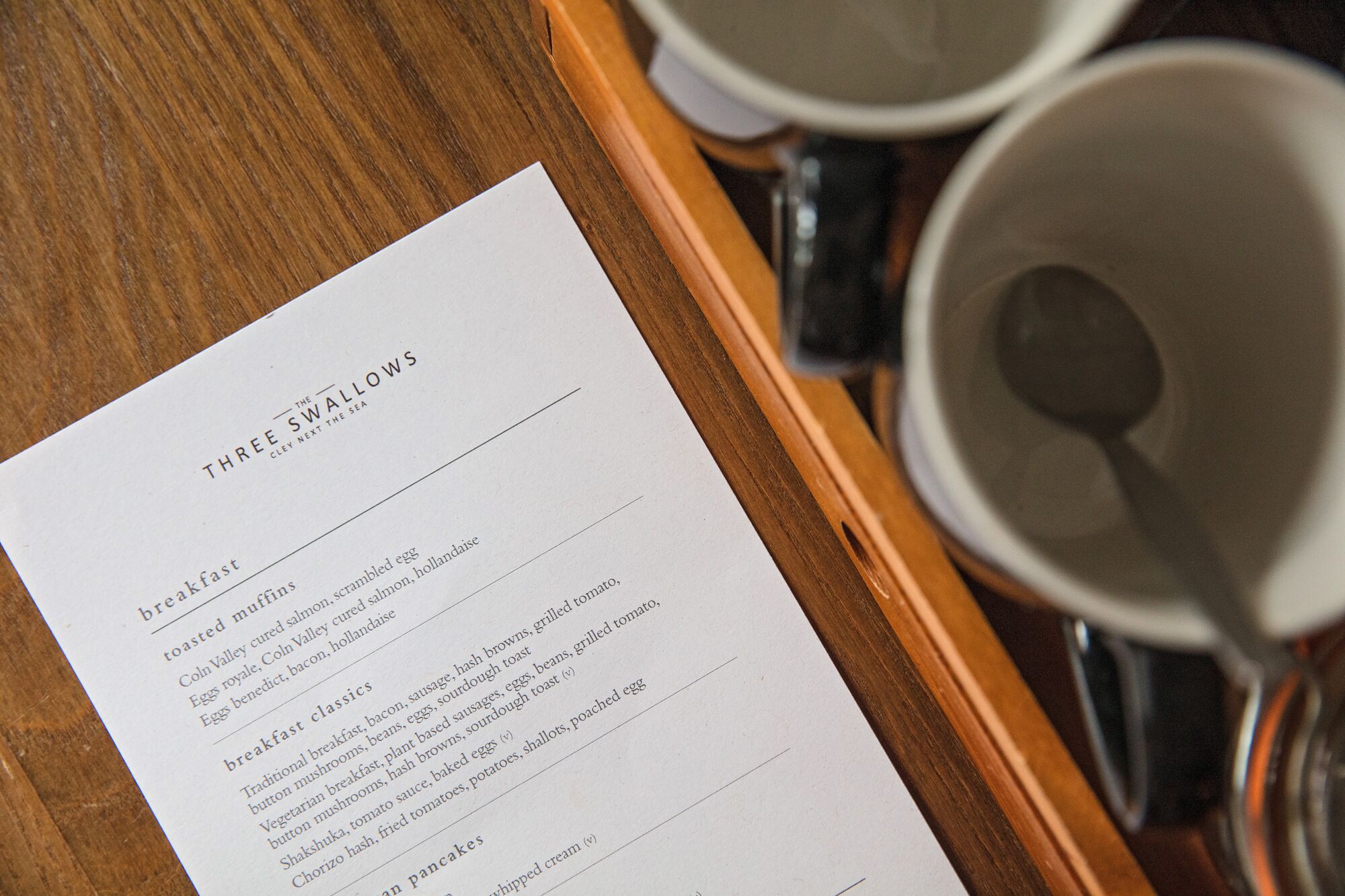 A menu titled "Three Swallows" with breakfast options like scrambled eggs and toast.