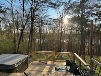 Lake view sunset by the hot tub, secluded by the trees and woods.