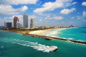 A coastal cityscape with high-rise buildings, a beach, and a pier. - Hot Tub BBQ Near Brickell W/ Free Parking (Miami)