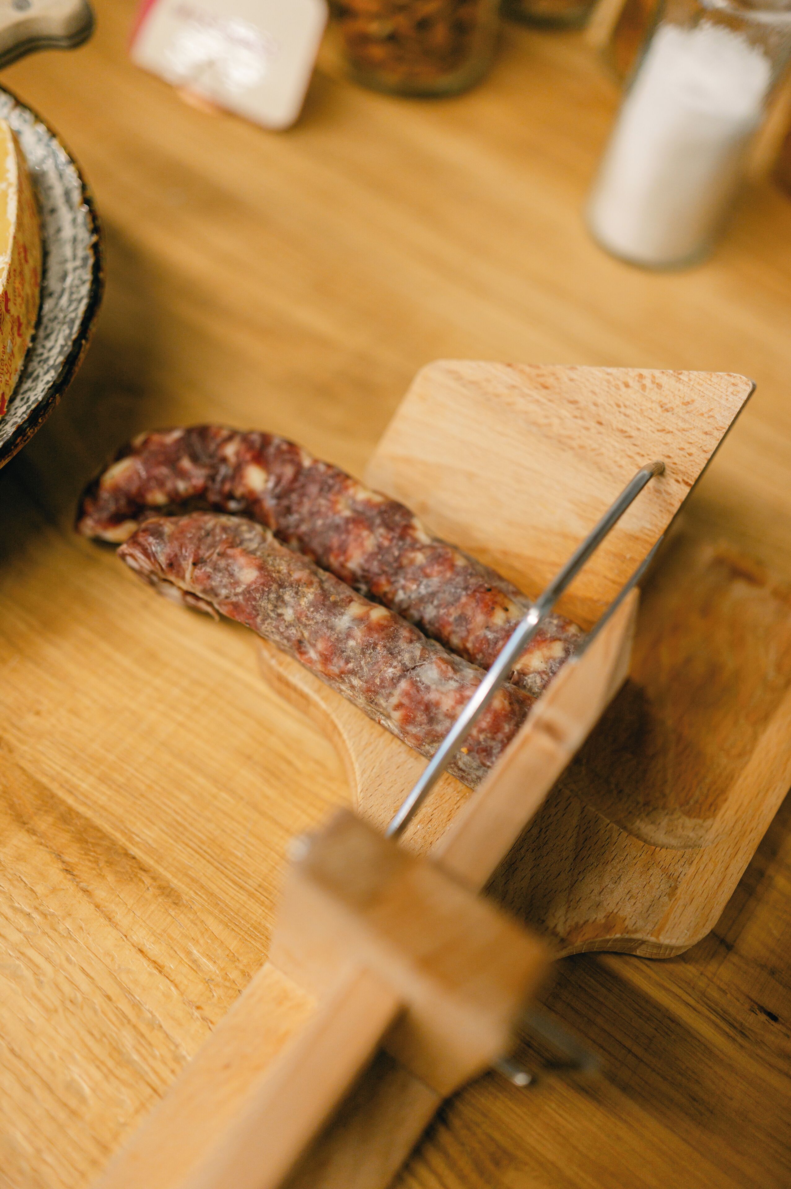 A wooden cutting board with a pair of scissors and a piece of meat on it.