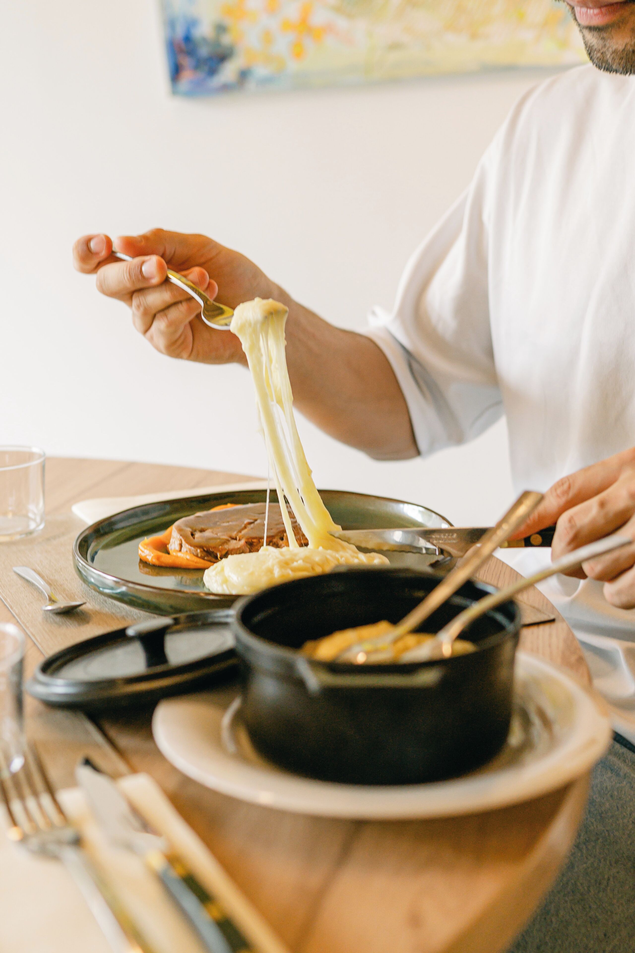 Une table à manger avec une assiette de nourriture, un bol et une cuillère.