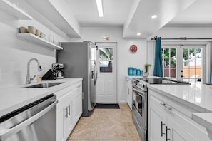 Enjoy cooking in this well-equipped kitchen with a refrigerator, oven, and dishwasher.