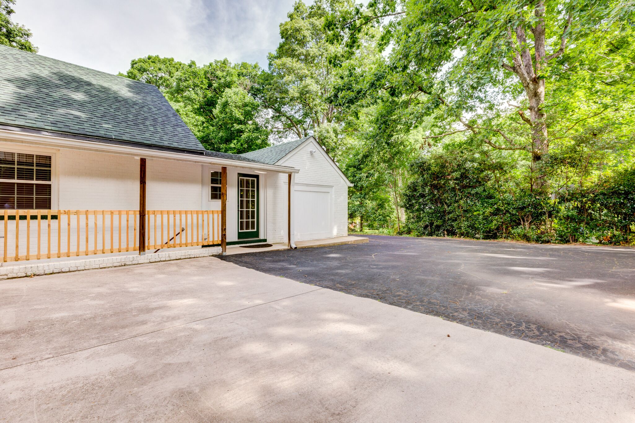 A single-story house with a garage, a covered porch, and a driveway.