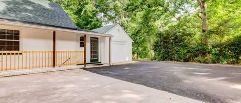 A single-story house with a garage, a covered porch, and a driveway.