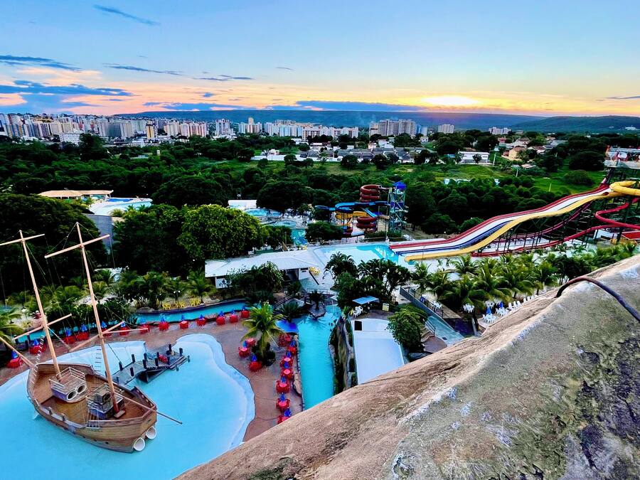 A water park with a large pool, slides, and a ship-themed area.