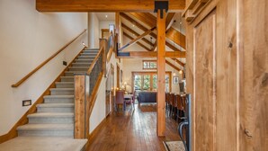 A wooden interior with a staircase, wooden beams, and a dining area. - Central Location w/ Suncadia Pool Access (Cle Elum)