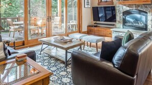 A cozy living room with a fireplace, a TV, and a comfortable seating area. - Central Location w/ Suncadia Pool Access (Cle Elum)